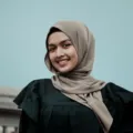 Perempuan berhijab modis mengenakan tren hijab kekinian simpel berwarna pastel netral